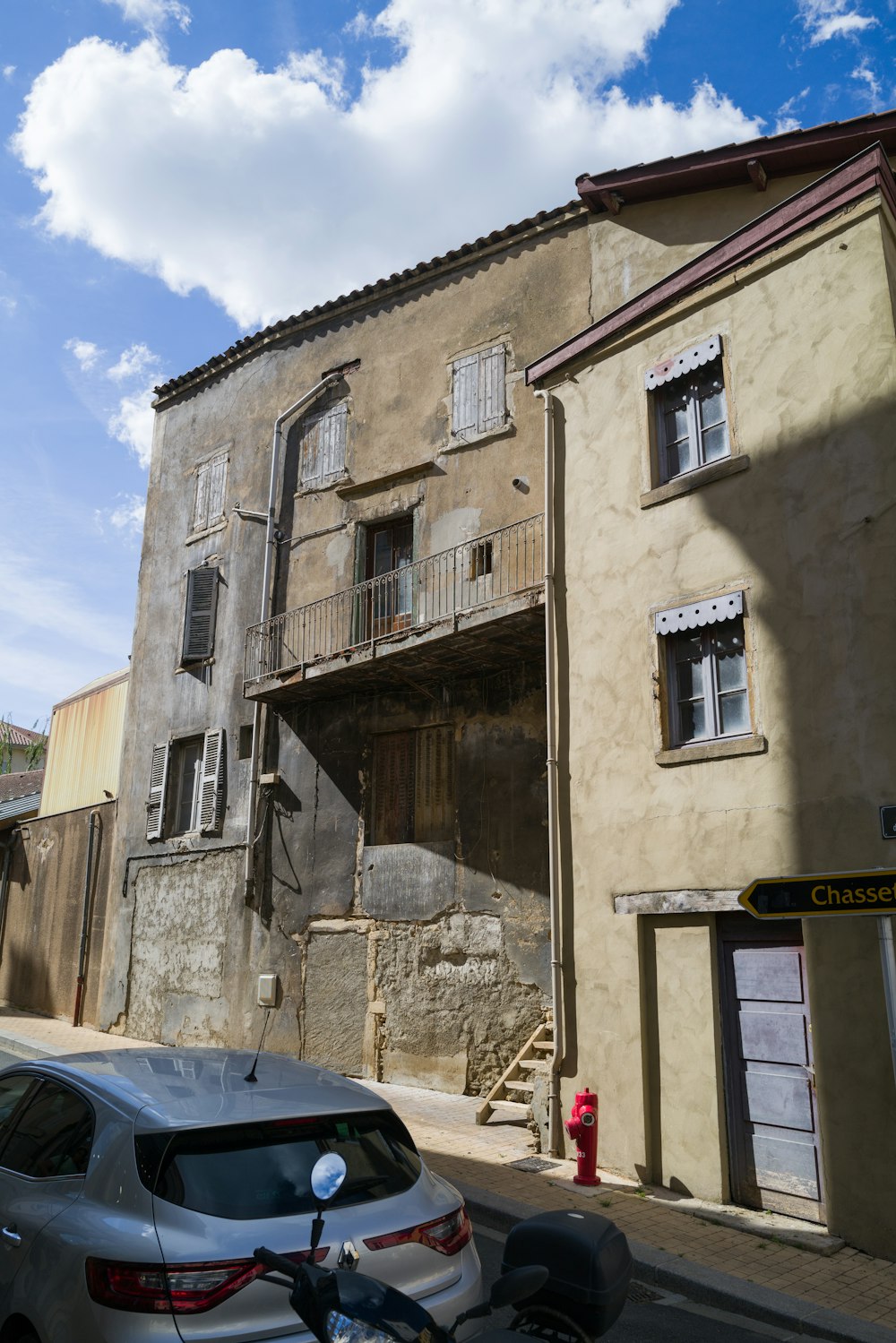 a car parked on the side of a street next to a building