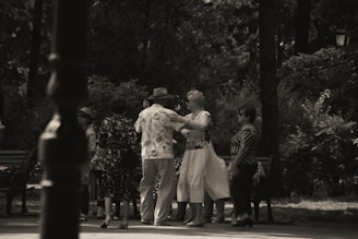 Smiling elderly people playing and dancing together in a bright, spacious community room