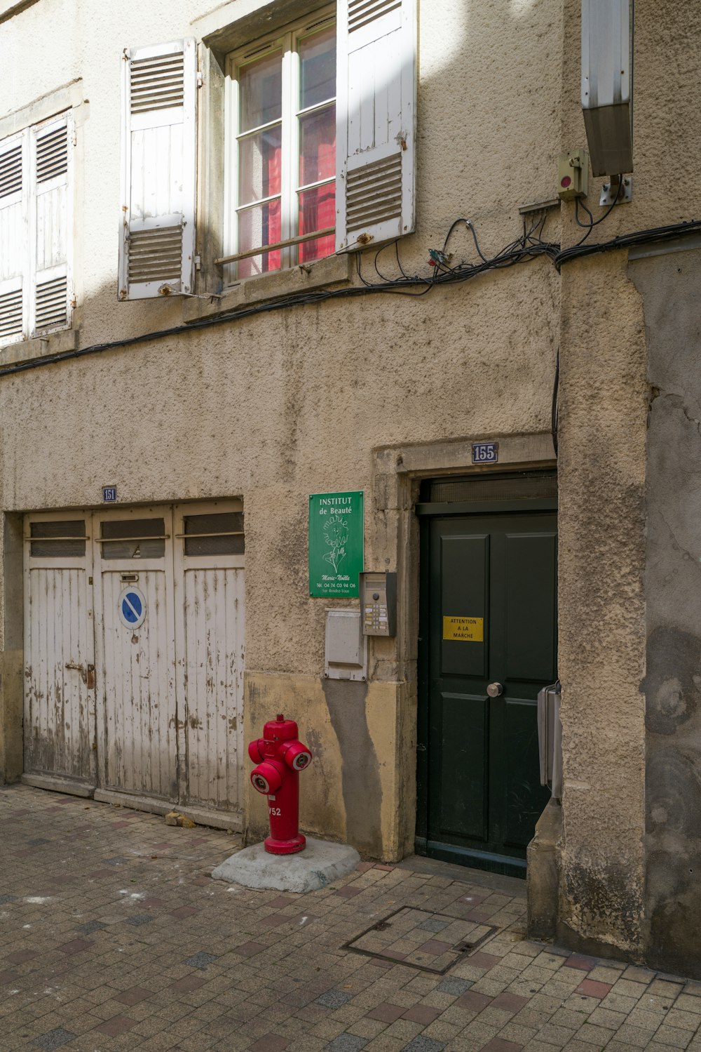 a red fire hydrant in front of a building