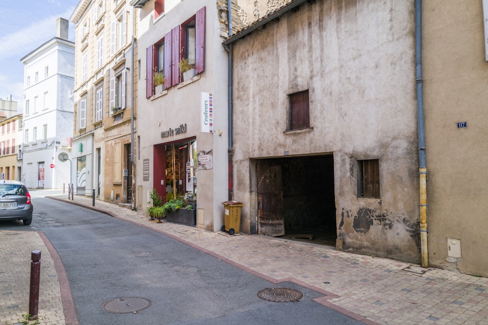 a car parked on the side of a street next to a building