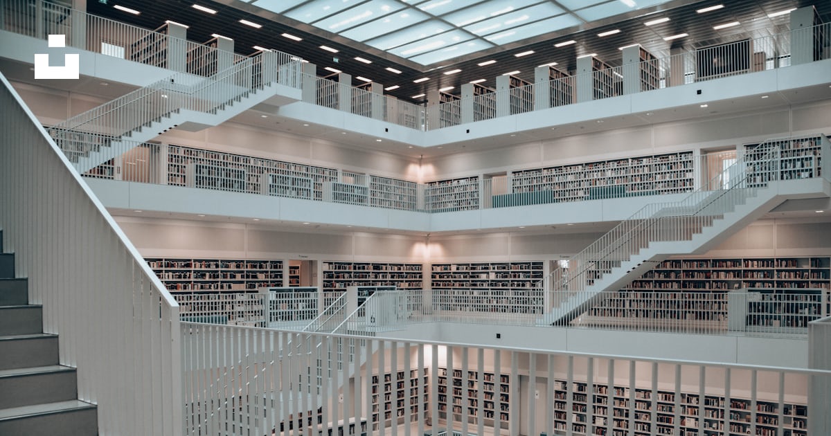 A large library filled with lots of books photo – Free Grey Image on ...