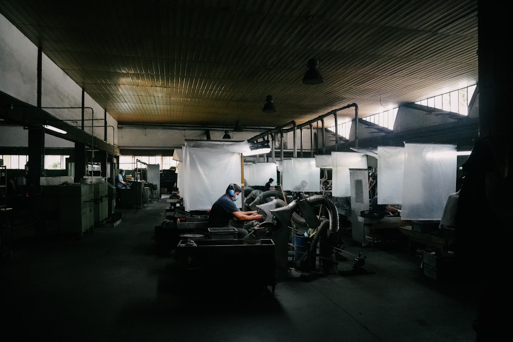 a group of men working on a car in a garage