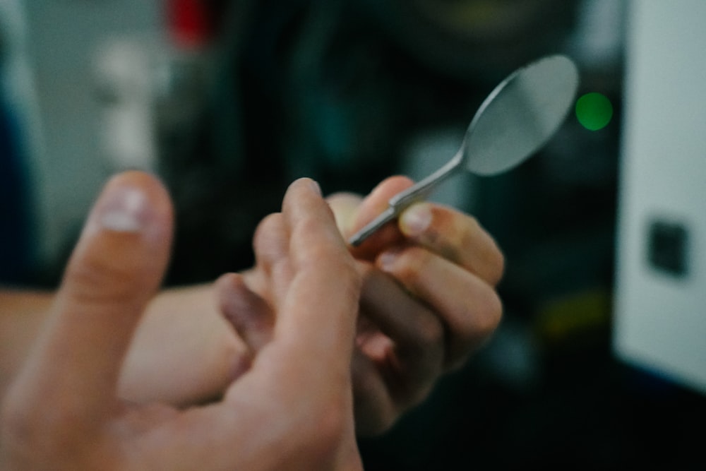 a close up of a person holding a spoon