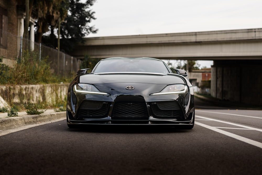 a black sports car parked on the side of the road