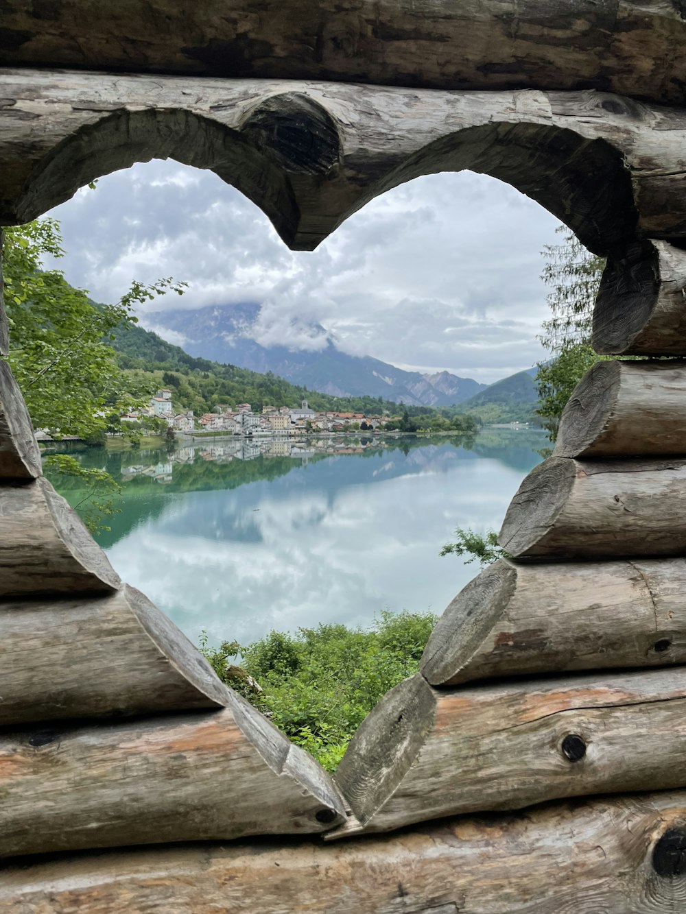 a heart shaped window in a log cabin