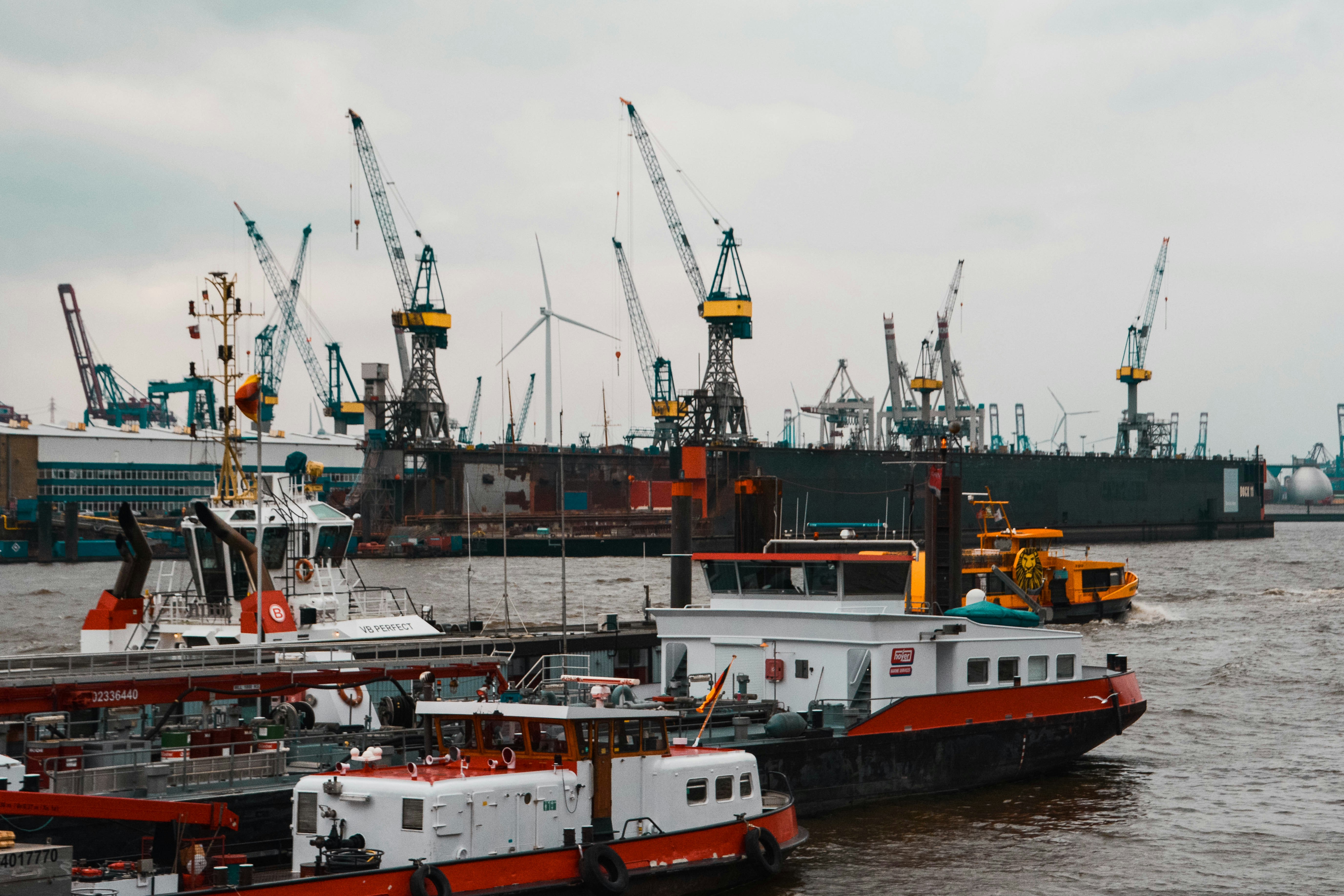 a large boat in the water next to other boats