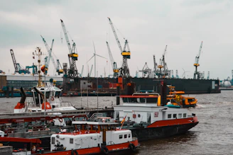 a large boat in the water next to other boats