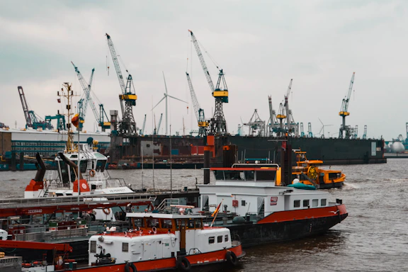 a large boat in the water next to other boats