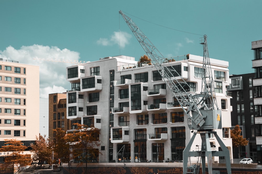 a crane is standing in front of a building