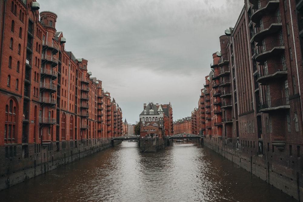 a river running through a city next to tall buildings