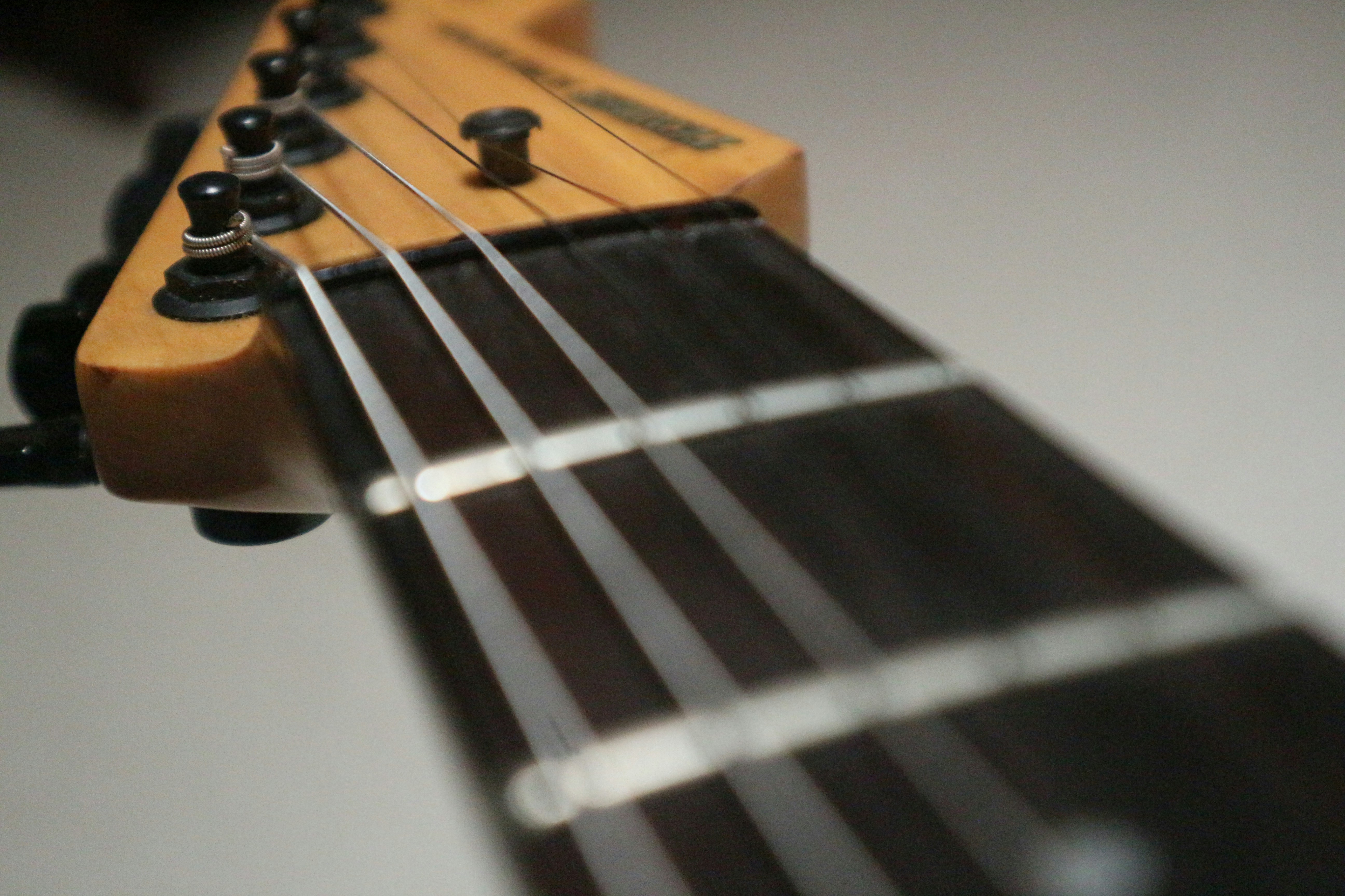 a close up of a guitar neck and strings