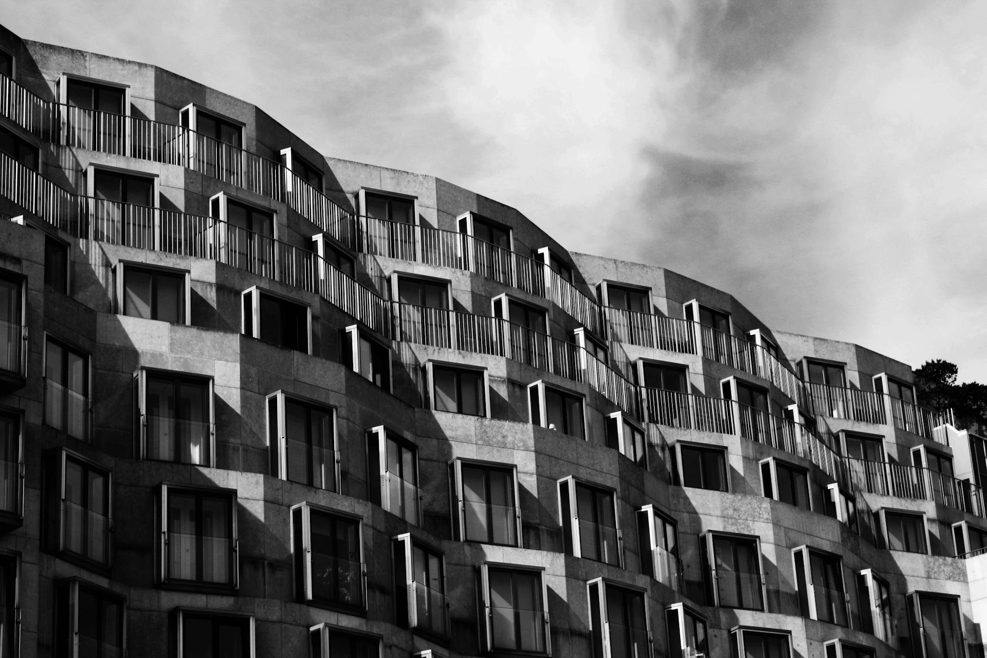 a black and white photo of a building with balconies