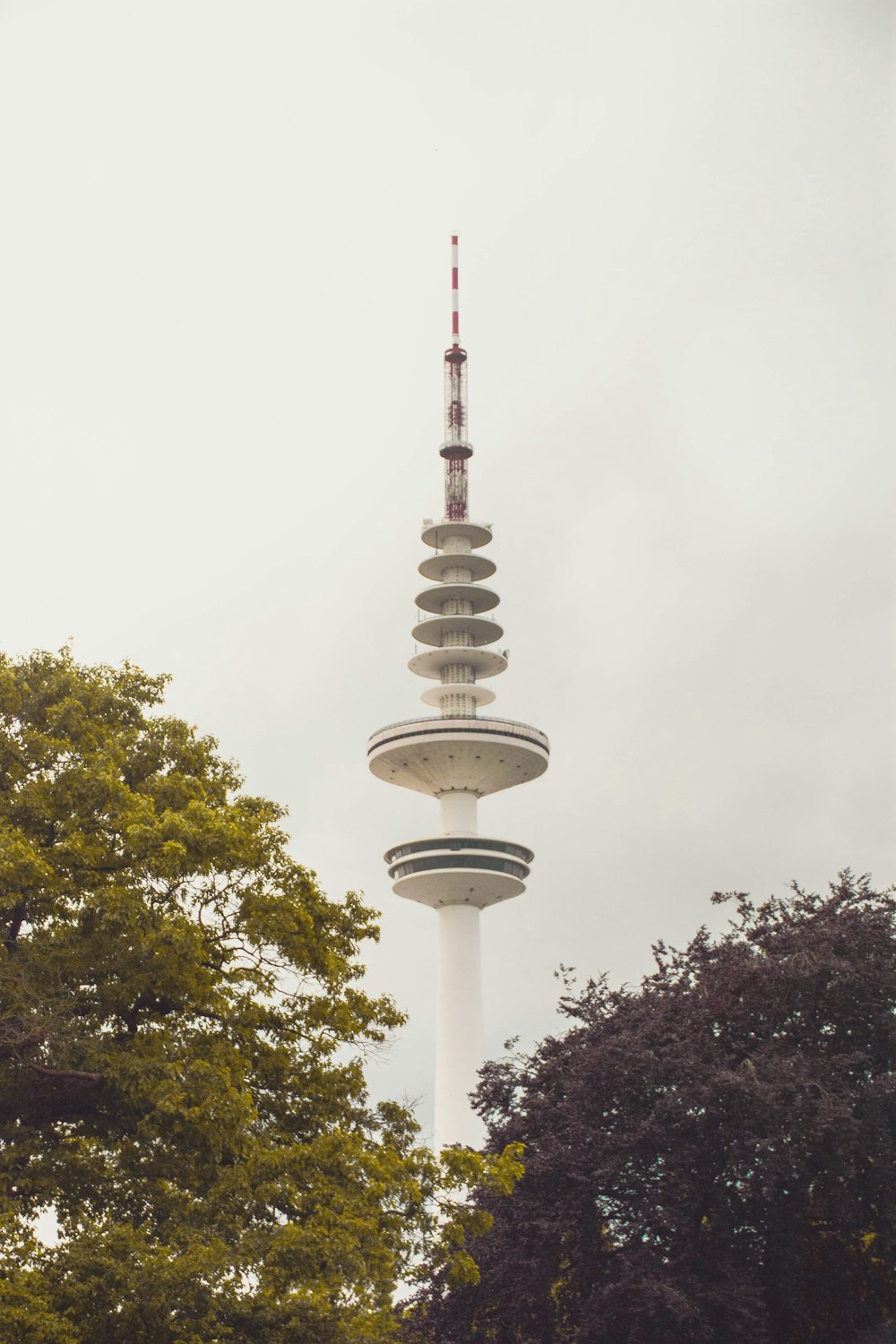 a tall white tower with a clock on it's side