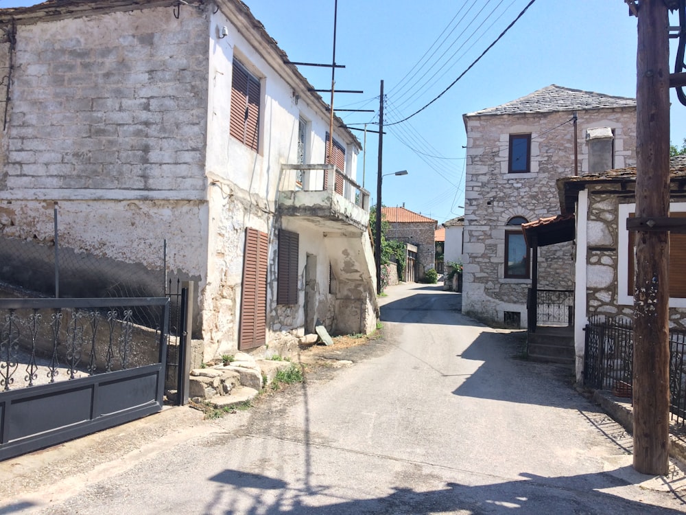a narrow street in a small village with old buildings