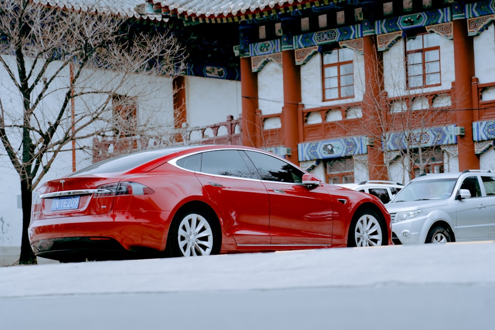 a red car parked in front of a building