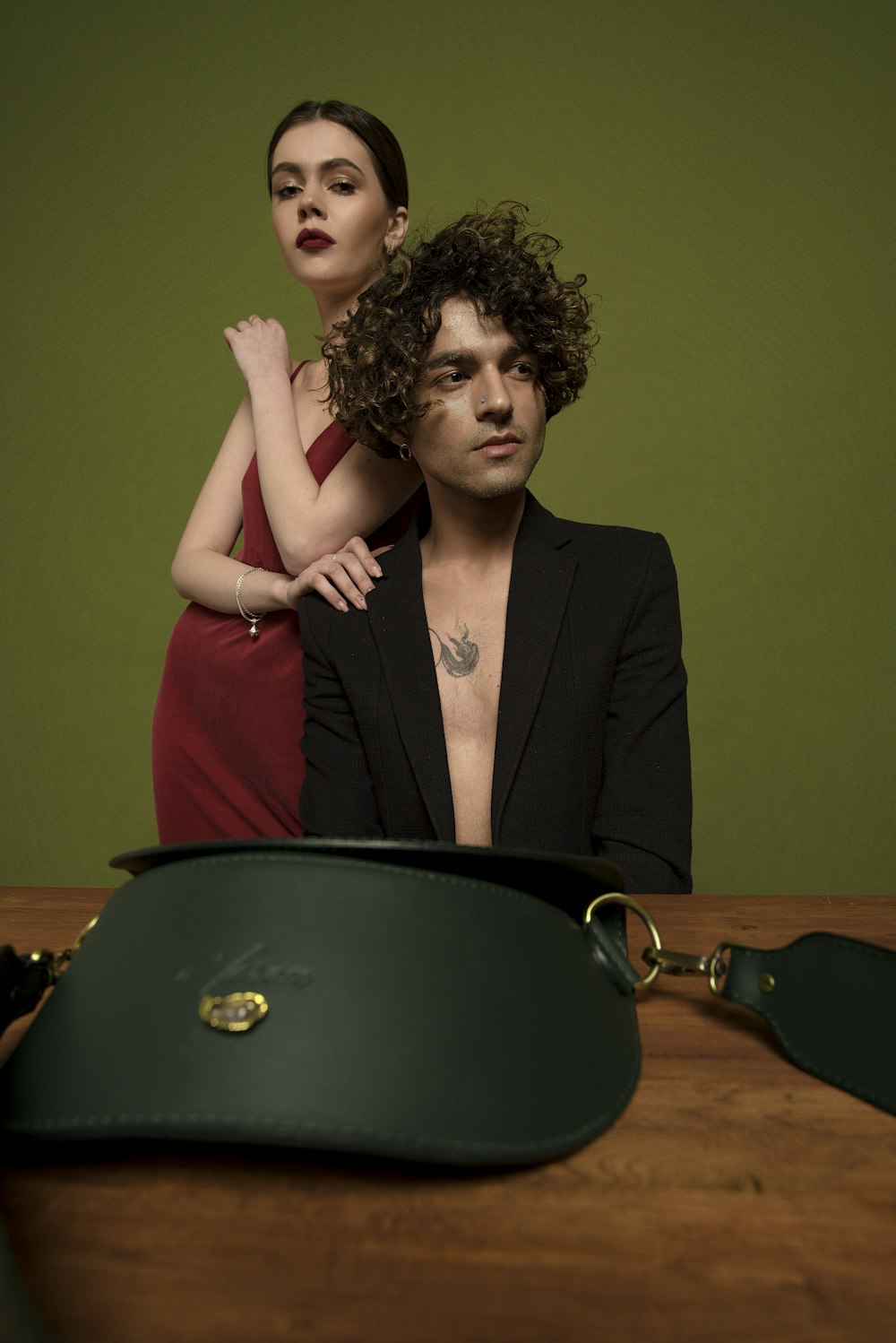 a man and a woman standing next to a purse