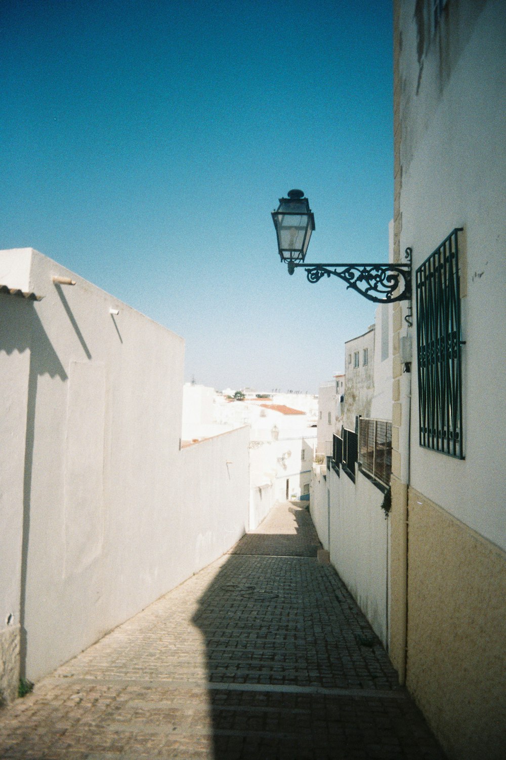 a street with a lamp on the side of it