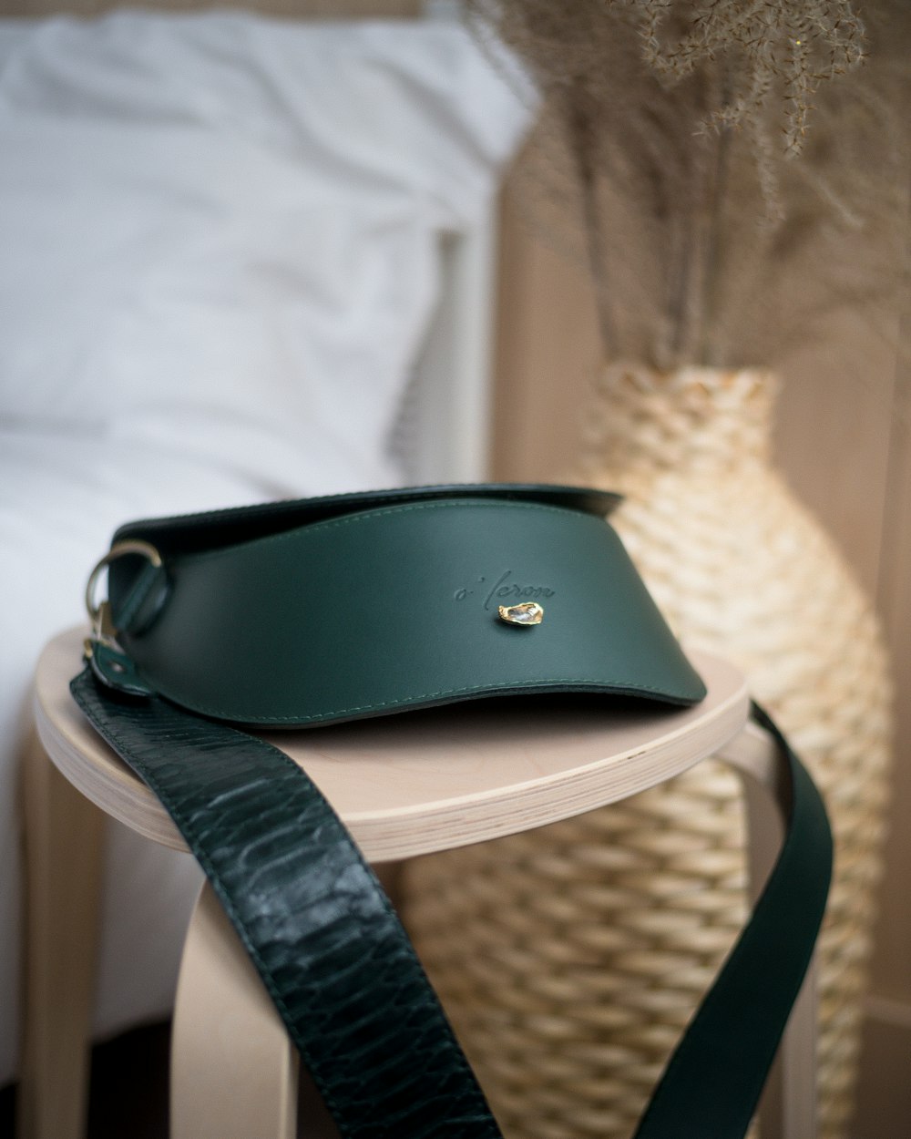 a green leather purse sitting on top of a table
