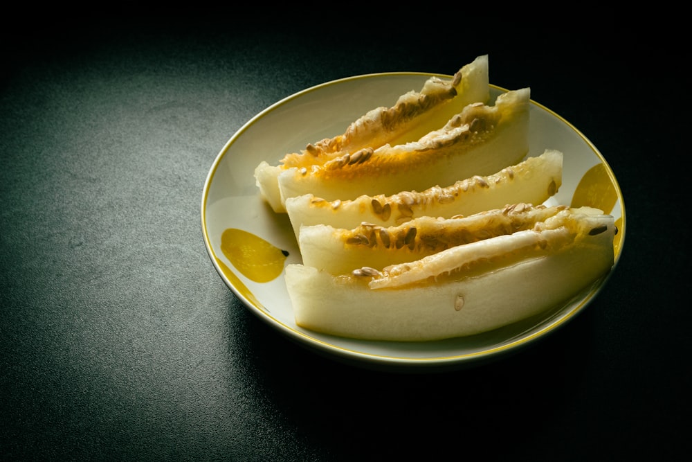 a white plate topped with sliced bananas on top of a table