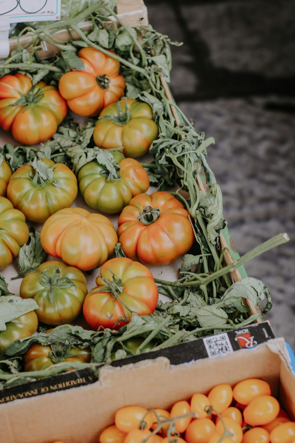 a box full of tomatoes sitting on top of a table