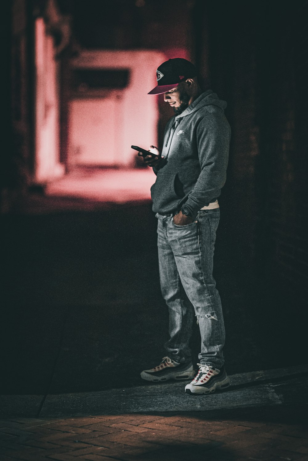 a man standing in the dark with a cell phone