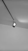 Close-up of a ceiling track lift smoothly moving along its rail inside a cozy living room.