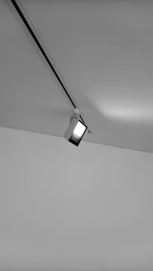 Close-up of a ceiling track lift smoothly moving along its rail inside a cozy living room.