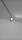 A ceiling-mounted spotlight is illuminating a portion of a smooth, flat ceiling. The spotlight appears to be attached to an adjustable track system.