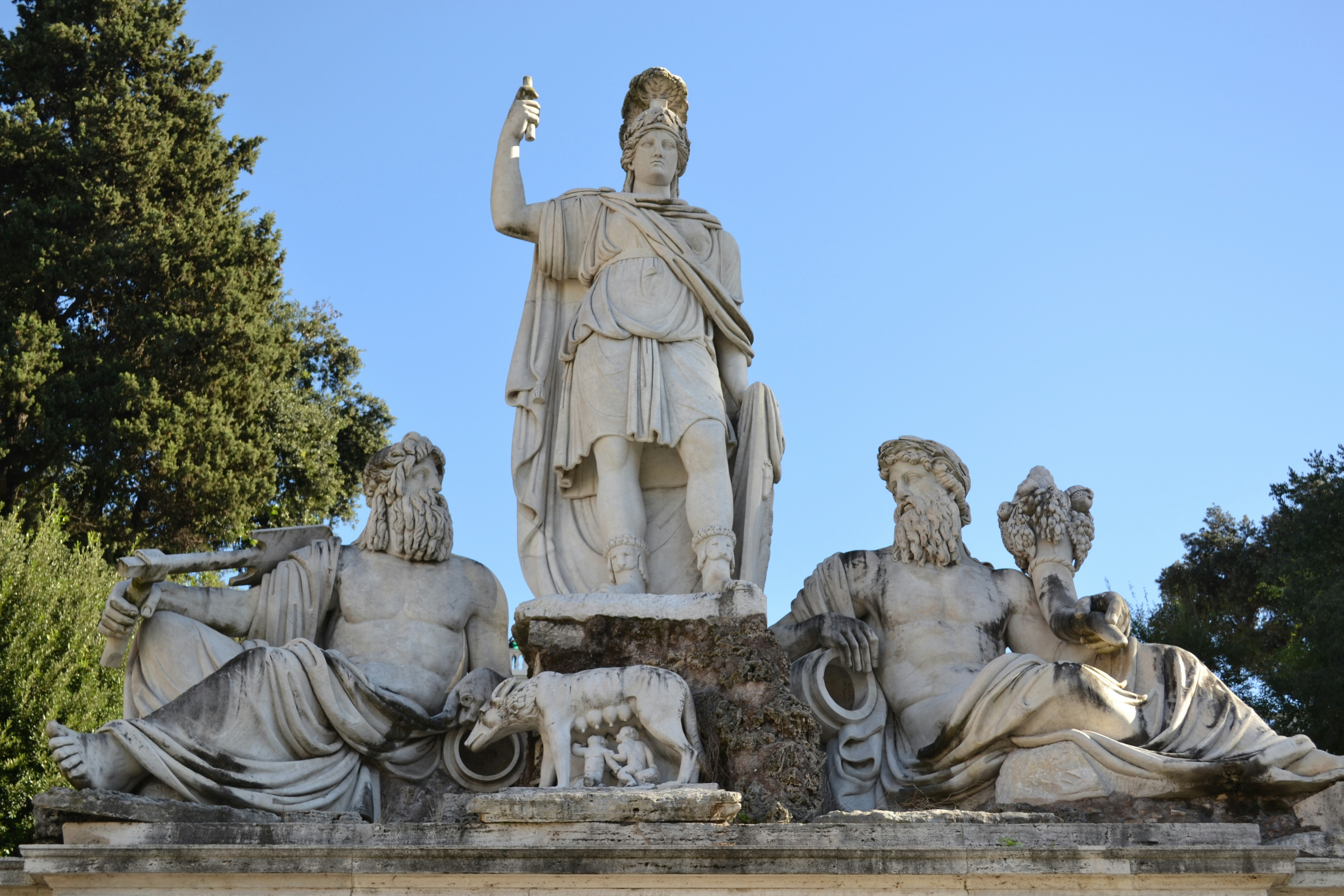 a statue of a man standing next to other statues