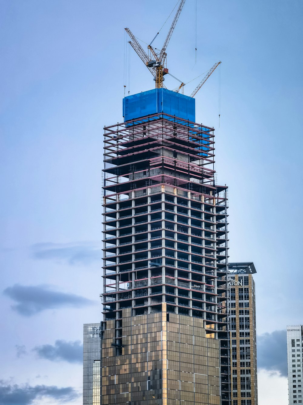 a tall building with a crane on top of it