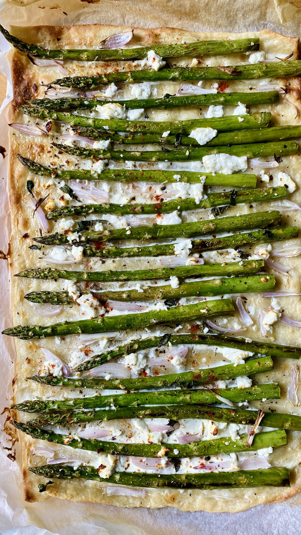 a pizza topped with asparagus and cheese