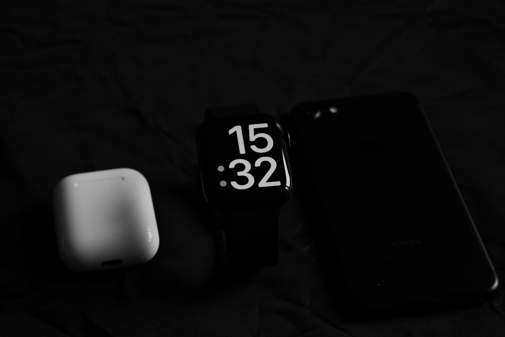 a smart phone sitting next to a smart watch