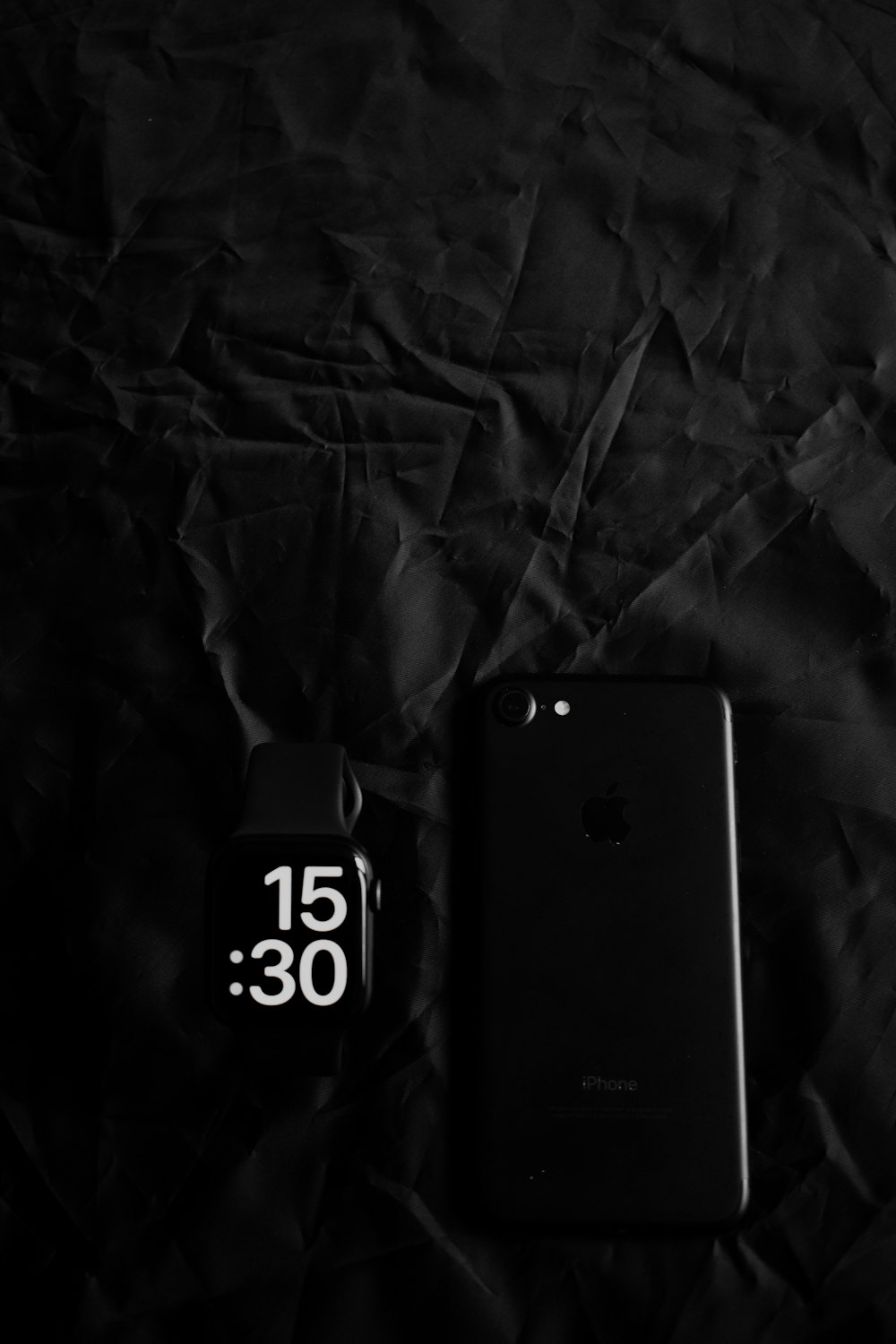 a cell phone sitting on top of a black sheet