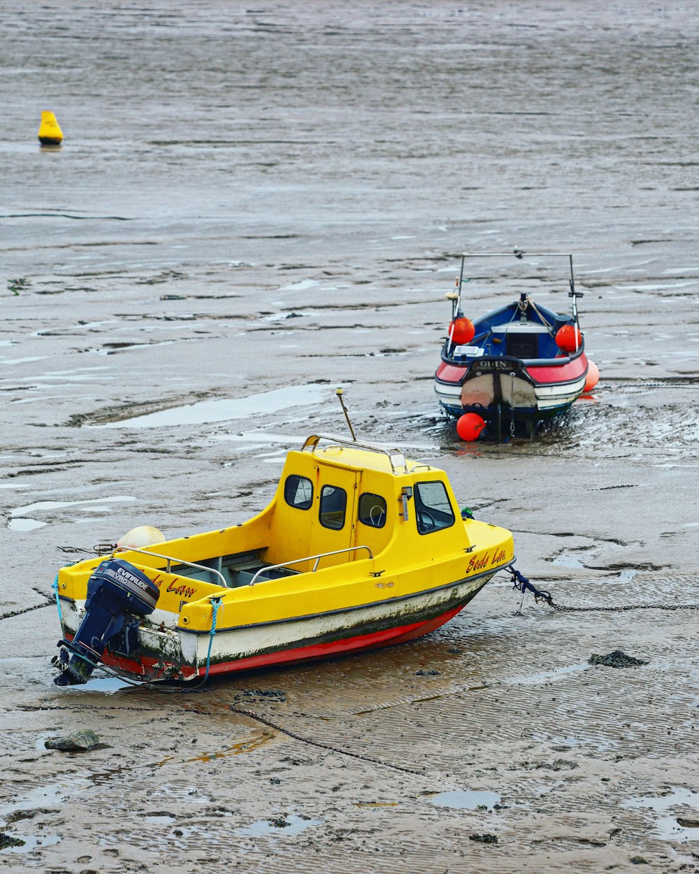 a couple of small boats floating on top of a body of water