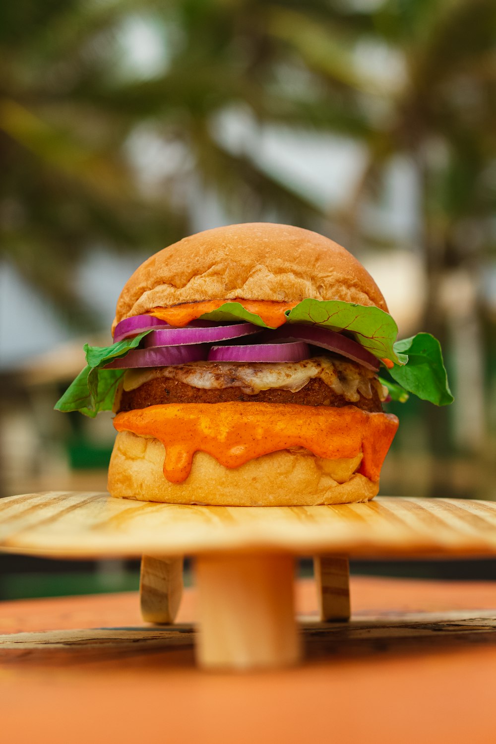 a hamburger sitting on top of a wooden table