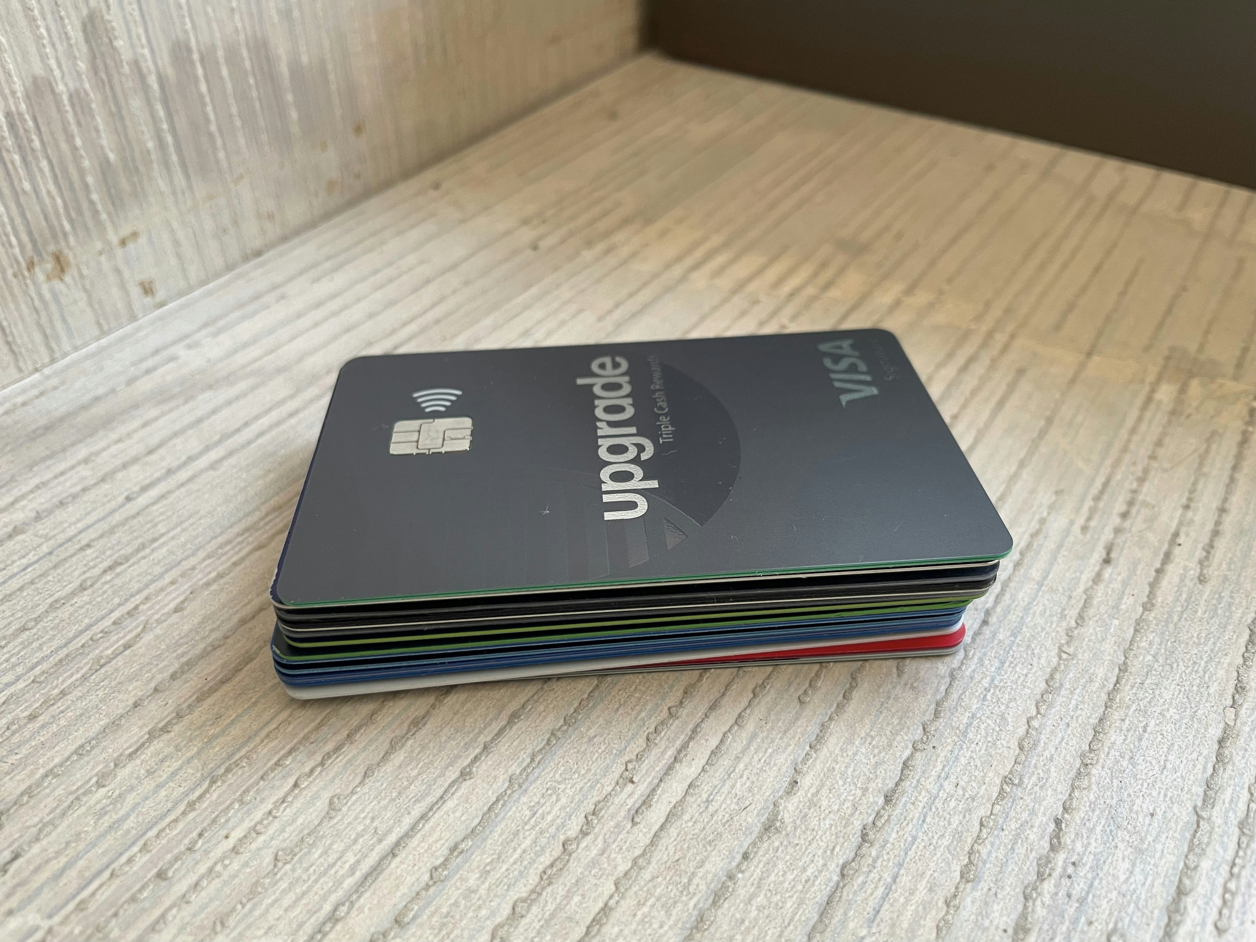 Stack of prepaid payment cards against dark metallic surface, close-up studio lighting