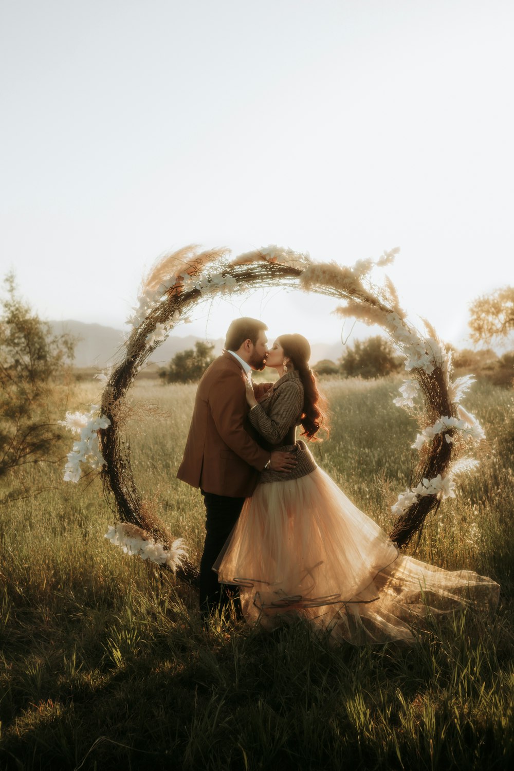 a man and a woman standing in a field