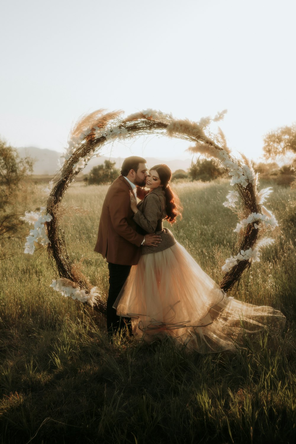 a man and a woman standing in a field