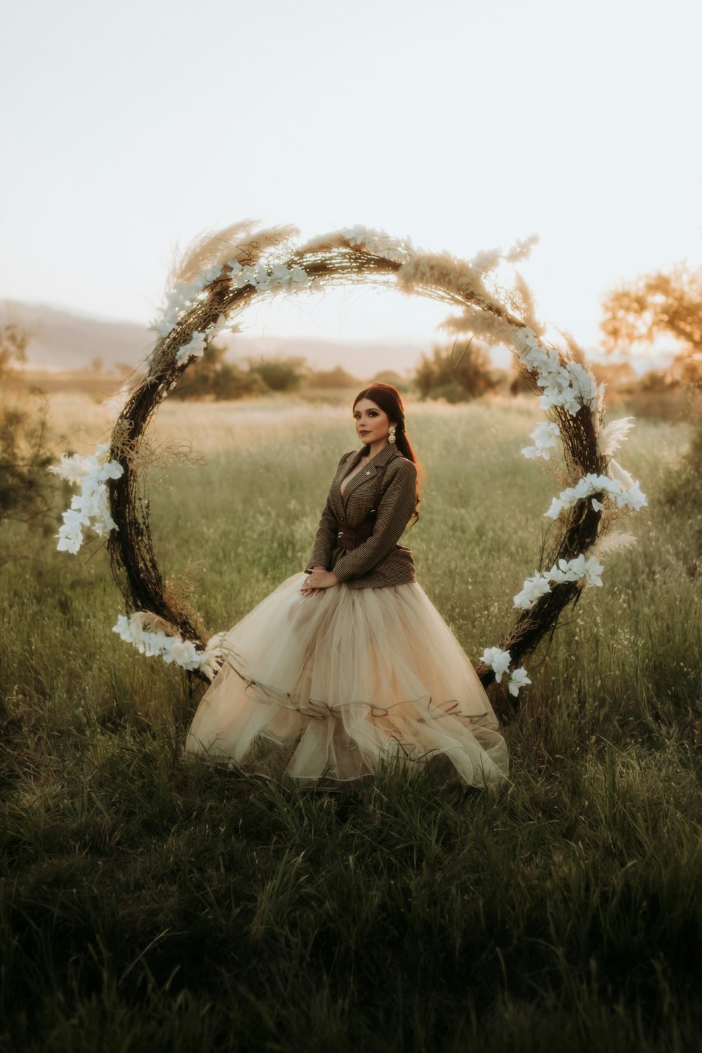 a woman in a dress standing in a field