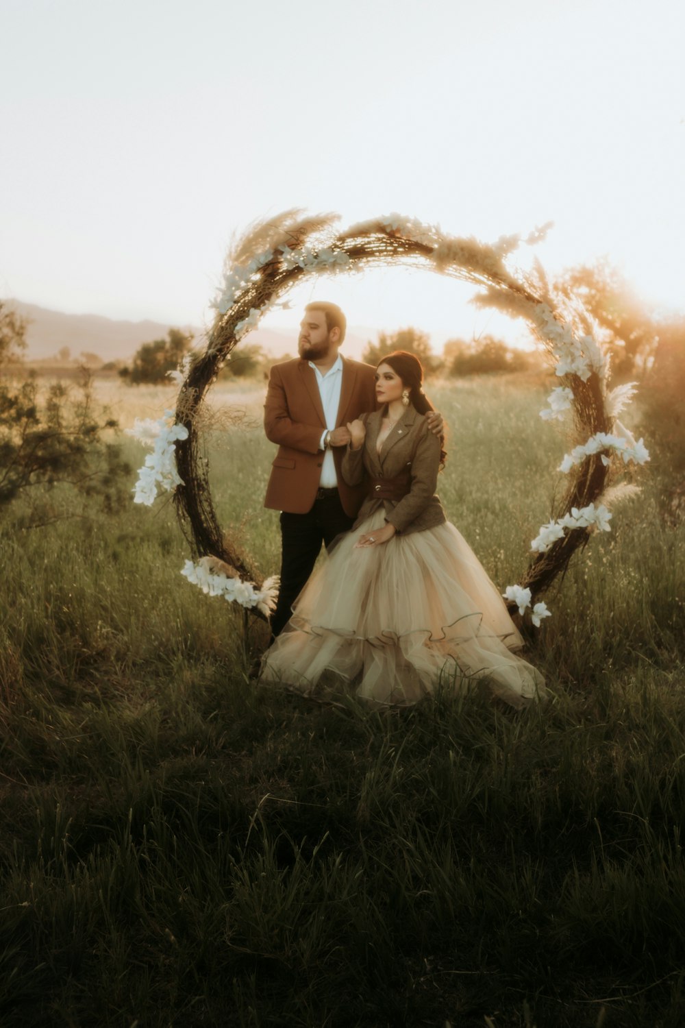 a man and a woman standing in a field