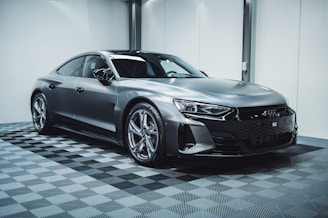 a silver car parked in a garage with a checkered floor