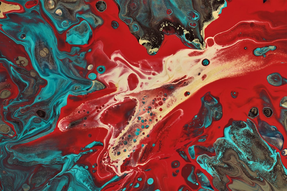 a close up of a red and blue fluid painting