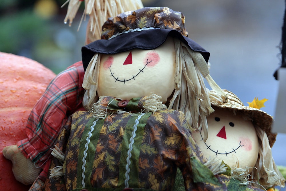 a couple of scarecrows sitting next to each other