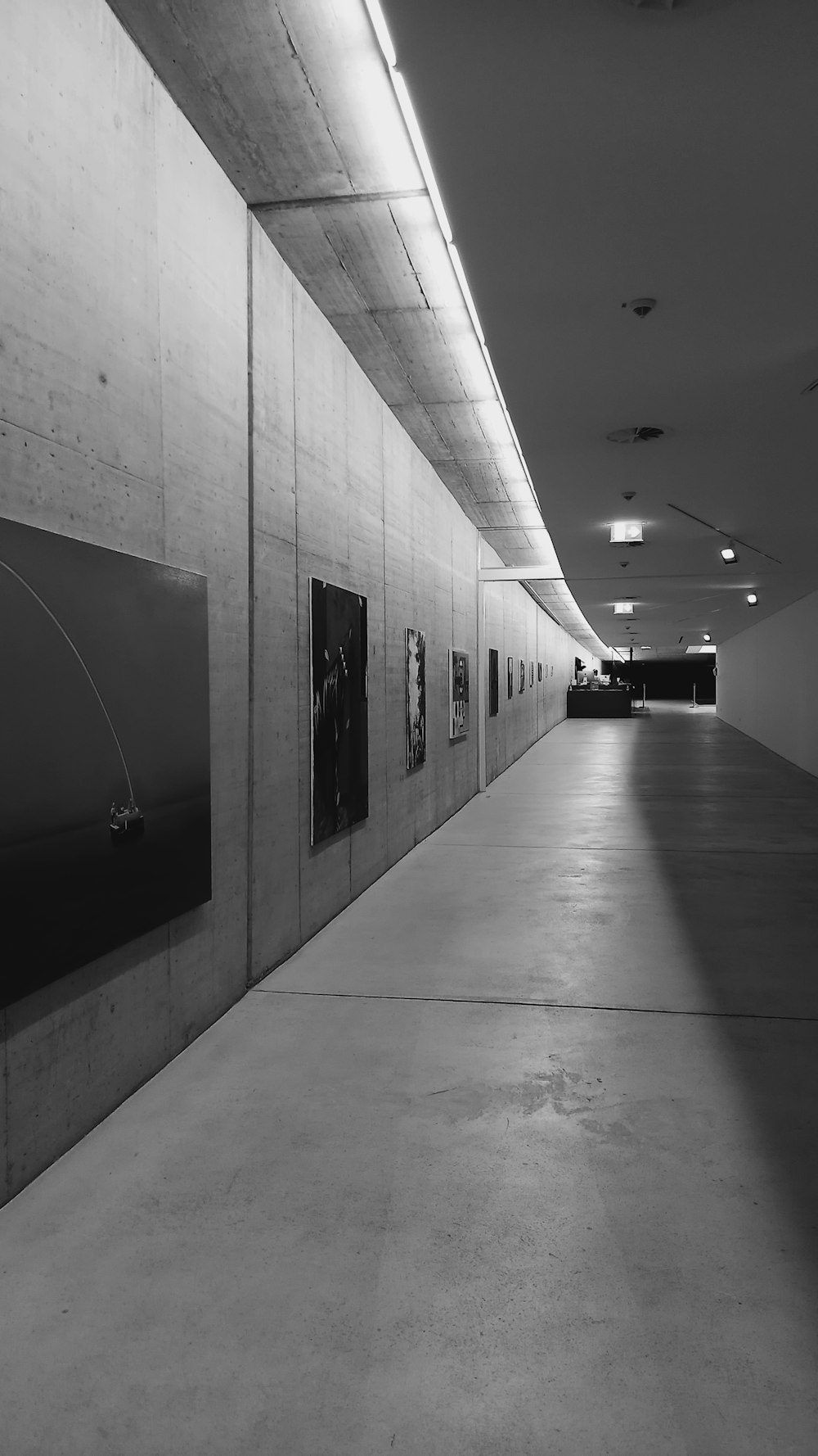 a black and white photo of a long hallway