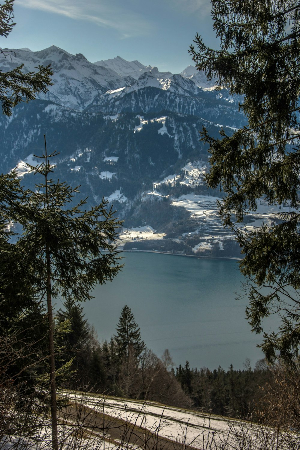 a scenic view of a mountain range with a lake in the foreground