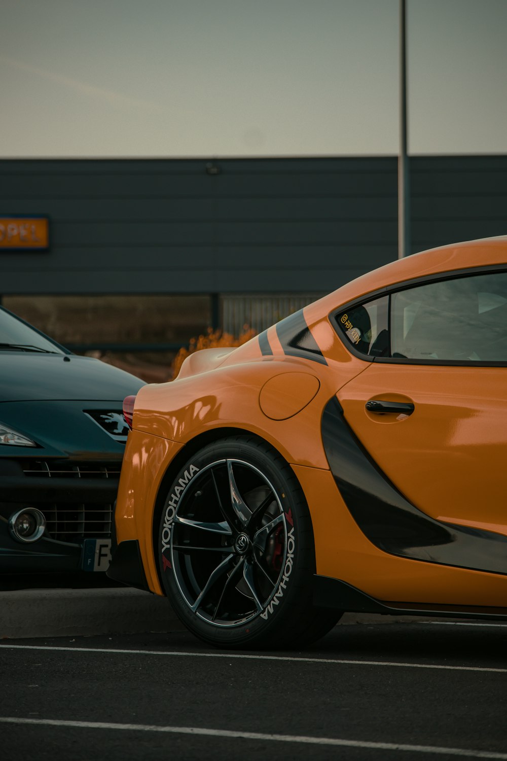 an orange sports car parked in a parking lot