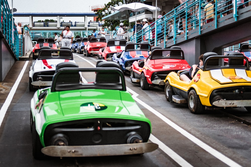 a group of cars driving down a street next to a bridge