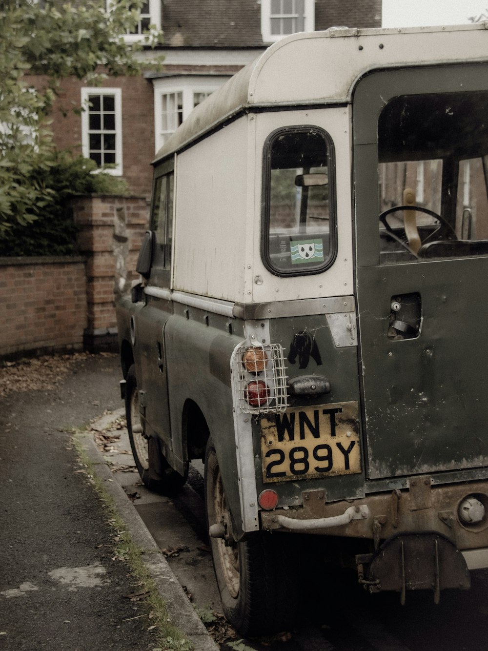 an old truck parked on the side of the road