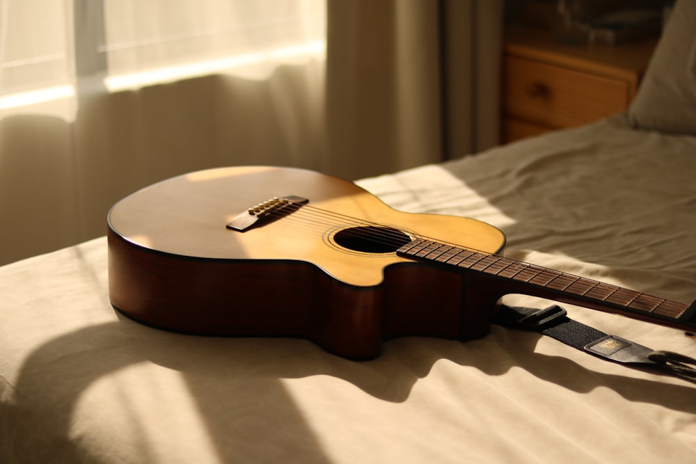 a guitar laying on a bed in a room