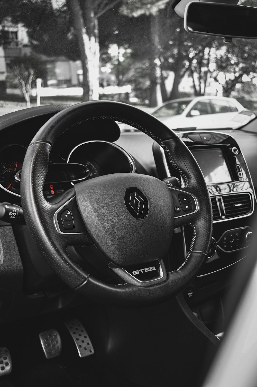 a black and white photo of a car dashboard